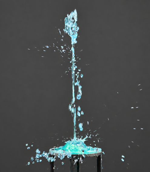 Water propelled upward from a deformable structure during a fluid transport experiment.